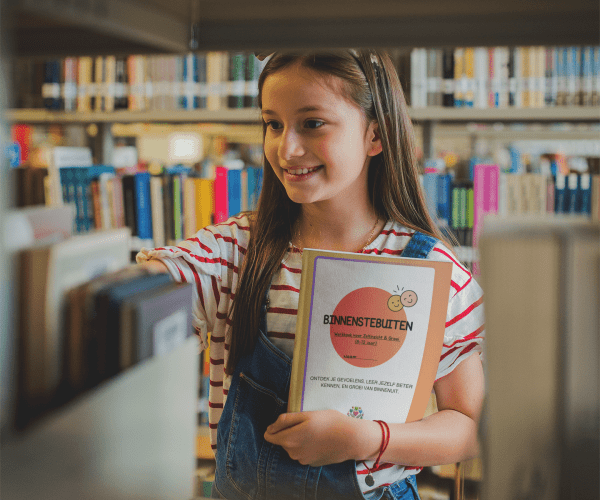 smiling-girl-holding-a-book-template-at-a-library-a19275